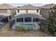 Aerial view of a home with a screened pool and patio in a residential neighborhood at 1494 Moon Valley Dr, Davenport, FL 33896
