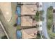 Overhead shot of adjacent homes each featuring a screened pool in a residential community at 1494 Moon Valley Dr, Davenport, FL 33896