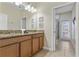 Bathroom with double sinks, granite countertops, and a glass-enclosed shower at 1494 Moon Valley Dr, Davenport, FL 33896