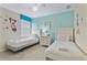 Twin bedroom with colorful wall decals and two comfortable beds at 1494 Moon Valley Dr, Davenport, FL 33896