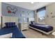 ' bedroom with two twin beds, cartoon decor, and a large window for natural light at 1494 Moon Valley Dr, Davenport, FL 33896