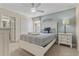 Well-lit bedroom with a queen-size bed, white furniture, and soft blue accents at 1494 Moon Valley Dr, Davenport, FL 33896