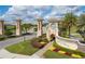 Champions Gate community entrance showcasing well manicured landscaping and signage at 1494 Moon Valley Dr, Davenport, FL 33896