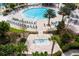 Aerial view of a resort-style community pool with lounge chairs and palm trees at 1494 Moon Valley Dr, Davenport, FL 33896