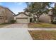 Two-story home with brick paver driveway, attached two car garage, and well maintained lawn at 1494 Moon Valley Dr, Davenport, FL 33896