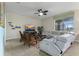 Cozy living room with tile floors, ceiling fan, entertainment center, and comfortable seating at 1494 Moon Valley Dr, Davenport, FL 33896