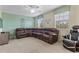 Spacious living room featuring a plush leather sectional sofa and a ceiling fan at 1494 Moon Valley Dr, Davenport, FL 33896