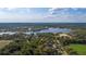 Lakeside estate with a swimming pool and sport fields, set against a backdrop of woods at 1501 Lake Markham Rd, Sanford, FL 32771