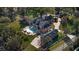 Sprawling brick estate with a pool, surrounded by lush landscaping from an aerial perspective at 1501 Lake Markham Rd, Sanford, FL 32771