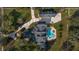 Overhead view of a brick estate with a grand driveway and luxurious pool area at 1501 Lake Markham Rd, Sanford, FL 32771