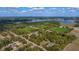 Expansive property featuring a sports field and lake, viewed from above at 1501 Lake Markham Rd, Sanford, FL 32771