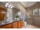 Elegant bathroom with vessel sinks, granite countertops, tiled walls, and glass shower enclosure at 1501 Lake Markham Rd, Sanford, FL 32771