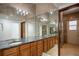 Lavish bathroom features marble tiling, granite counters, double sinks, and expansive mirror at 1501 Lake Markham Rd, Sanford, FL 32771
