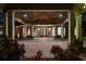 Grand entrance with brick columns, arched windows, and a striking wood door, surrounded by lush landscaping at 1501 Lake Markham Rd, Sanford, FL 32771