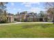 Elegant brick home featuring a covered walkway, lush lawn and mature landscaping at 1501 Lake Markham Rd, Sanford, FL 32771