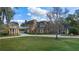 Elegant brick home featuring a covered walkway, lush lawn and mature landscaping at 1501 Lake Markham Rd, Sanford, FL 32771
