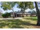Elegant brick home with manicured lawn and a circular driveway approach at 1501 Lake Markham Rd, Sanford, FL 32771