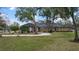 Elegant home features arched windows and a circular driveway surrounded by lush landscaping at 1501 Lake Markham Rd, Sanford, FL 32771