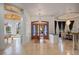 Inviting foyer with stone floors, chandelier, bar area, pool table, and a view into the dining room at 1501 Lake Markham Rd, Sanford, FL 32771