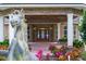 Stunning front entrance with double doors, brick accents, a horse statue, and colorful landscaping elements at 1501 Lake Markham Rd, Sanford, FL 32771