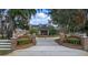 Beautiful estate home featuring brick entrance with landscaped garden, water feature, and manicured grounds under a blue sky at 1501 Lake Markham Rd, Sanford, FL 32771