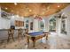 Entertaining game room with a pool table, bar area, and abundant natural light at 1501 Lake Markham Rd, Sanford, FL 32771