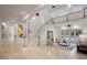 Spacious living room featuring high ceilings, neutral decor, staircase to upper level gallery and view of the pool at 1501 Lake Markham Rd, Sanford, FL 32771