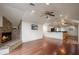 Inviting living space with stone fireplace, hardwood floors, and kitchen area at 1501 Lake Markham Rd, Sanford, FL 32771