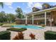 Gorgeous pool and spa surrounded by brick pavers, complemented by lush landscaping and a grand home at 1501 Lake Markham Rd, Sanford, FL 32771