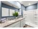 Well-lit bathroom with double sinks, granite countertops, and a step-in shower at 1835 Waggoner St, Kissimmee, FL 34744