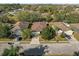 Aerial view of three single story homes with mature trees and landscaping in a residential neighborhood at 1843 Van Allen Loop, Auburndale, FL 33823