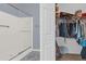 Bathroom features a stand-up shower with glass doors and a closet full of clothes at 1843 Van Allen Loop, Auburndale, FL 33823
