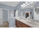 Bright bathroom with double sinks and convenient access to walk-in closet and separate rooms at 1843 Van Allen Loop, Auburndale, FL 33823