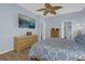 Comfortable primary bedroom features en-suite bathroom, calming blue tones, and wood floors at 1843 Van Allen Loop, Auburndale, FL 33823