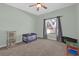 Bedroom offers a window, closet, play area, and ceiling fan for added comfort at 1843 Van Allen Loop, Auburndale, FL 33823