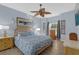 Relaxing bedroom featuring soft blue walls, light wood floors and decorative accents at 1843 Van Allen Loop, Auburndale, FL 33823