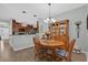 Open concept dining area with wood table and seamless flow to kitchen and living spaces at 1843 Van Allen Loop, Auburndale, FL 33823