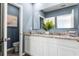 Bathroom featuring a double sink vanity with white cabinets, granite counters, and a framed mirror above at 1843 Waggoner St, Kissimmee, FL 34744