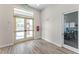 Bright entryway and lobby featuring glass doors, wood flooring, and visible office space beyond a glass door at 1847 Waggoner St, Kissimmee, FL 34744