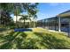 Expansive backyard features a trampoline, lush greenery, and view of the screened-in pool area at 1910 Lake Roberts Landing Dr, Winter Garden, FL 34787