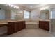 Bright bathroom with double sink vanity, soaking tub, and walk-in shower at 1910 Lake Roberts Landing Dr, Winter Garden, FL 34787