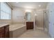 Bright bathroom featuring a tub, walk-in shower, and vanity with great lighting at 1910 Lake Roberts Landing Dr, Winter Garden, FL 34787