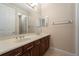 Bathroom featuring double sinks, great lighting, and wooden cabinets at 1910 Lake Roberts Landing Dr, Winter Garden, FL 34787