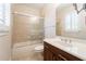 Bathroom with a tiled shower and tub, dark wood vanity, and tiled floors at 1910 Lake Roberts Landing Dr, Winter Garden, FL 34787
