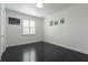 Bright bedroom with dark hardwood floors and a large window with shutters at 1910 Lake Roberts Landing Dr, Winter Garden, FL 34787