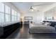 Bright bedroom with large windows, ceiling fan, modern decor and dark hardwood floors at 1910 Lake Roberts Landing Dr, Winter Garden, FL 34787