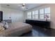 Bright bedroom with large windows, ceiling fan, modern decor and dark hardwood floors at 1910 Lake Roberts Landing Dr, Winter Garden, FL 34787
