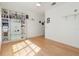 Bedroom with light hardwood floors, white walls, and a bookcase at 1910 Lake Roberts Landing Dr, Winter Garden, FL 34787