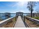 Picturesque view of the dock leading to a charming gazebo on the serene lake at 1910 Lake Roberts Landing Dr, Winter Garden, FL 34787