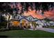 Charming two-story home showcasing a manicured lawn, and a welcoming entrance beneath a dramatic sky at 1910 Lake Roberts Landing Dr, Winter Garden, FL 34787